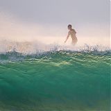 Wave, surfer in background