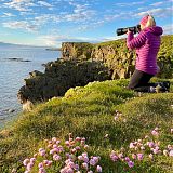 Photographer on the cliffs in Grímsey