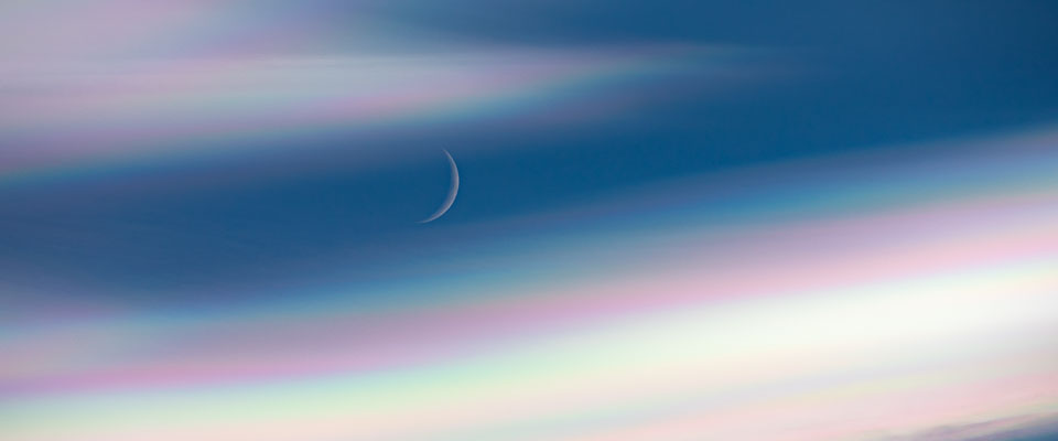 Moon behind nacreous clouds