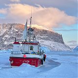 Fishing boat stuck in sea ice