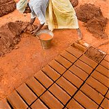 Woman fashioning bricks prior to firing, Madurai plains, Tamil Nadu, South India